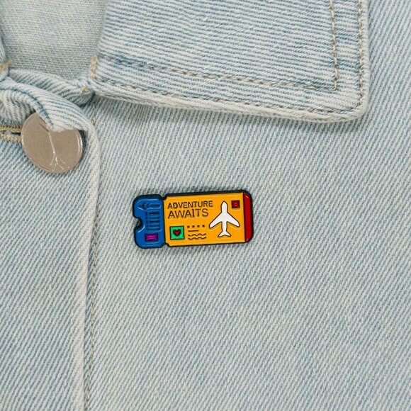 ⭐Enamel Pin Adventure Awaits Ticket Airplane Brooch Icon Cartoon Yellow New - Picture 1 of 5